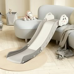 a child's slide in the middle of a living room with stuffed animals on it