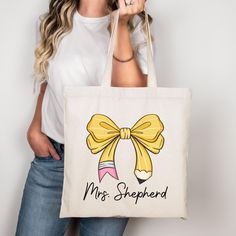 This 100% cotton Personalized Teacher bag comes in one size - 15" x 16"- perfect for everyday wear. While the canvas material of this Custom Teacher Tote will show off your designs in great colors, it's durable and will last for years. The gift for teacher bag features 20" handles (made from the same canvas), making it easy to carry even with all the teacher's essentials!  .: 100% cotton canvas .: Heavy fabric (12 oz/yd² (406.9 g/m .: Sewn-in label All teacher appreciation gifts are made to order! We do not accept returns, but if there are any issues with your product, then please reach out so we can make things right! Cotton Canvas Gift Bag, White Cotton Canvas Bag For Back To School, Canvas Bag For Back To School Gift, Back To School Canvas Bag Gift, Mother's Day Canvas Gift Bag For School, Yellow Cotton Canvas Gift Bag, Back To School Gift Cotton Canvas Bag, Back To School Gift Canvas Bag, White Canvas Bag For Back To School Gift