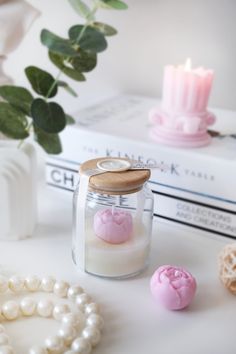 some candles and pearls are on a table