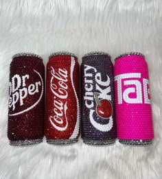 four different types of soda cans on a white background