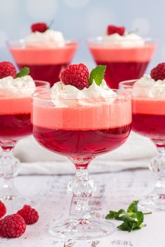 raspberry mousse with whipped cream and mint garnish in wine glasses