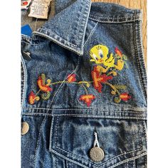 Tweety Bird Sz Medium Denim Vest Jean Jerry Leigh Looney Tunes Nwt. Rare Find! Jerry Leigh For Looney Tunes Denim Vest With Embroidered Tweety, Bird And Tweety Bird Embossed Buttons Brand New With Tags Measures Approximately: 21 Inches In Length 18 Inches Pit To Pit 28 Inch Waist Ships Quickly From A Smoke Free Environment Retro Blue Denim Vest For Fall, Retro Dark Wash Denim Jacket For Spring, Retro Blue Denim Jacket For Spring, Retro Spring Denim Vest, Spring Retro Blue Denim Jacket, Retro Denim Vest For Spring, Blue Denim Vest For Spring In 90s Style, Vintage Blue Denim Jacket For Spring, Vintage Denim Vest For Spring