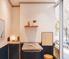 an empty room with a table and stool in it