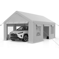 a white car is parked in front of a tent with the door open to show it's interior