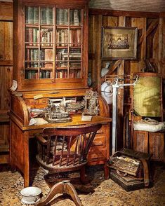 an old fashioned desk and bookshelf in a room