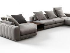 a large sectional couch with pillows on it's back and side facing each other