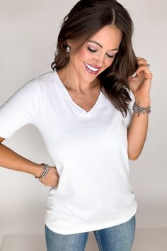 "Stay comfortable and stylish with our SR Basic Cotton White V-Neck Short Sleeve Tee Shirt. Made with super soft and stretchy fabric, this tee is not only flattering but also the perfect addition to your wardrobe. Get ready to rock your new favorite everyday essential!" Fit: She is wearing her true size medium. Fits true to size. If in between sizes, size down. Stretchy Fabric, Online Boutique, Everyday Essentials Products, Short Sleeve Tee, Tee Shirt, Get Ready, Tee Shirts, Size Medium, V Neck