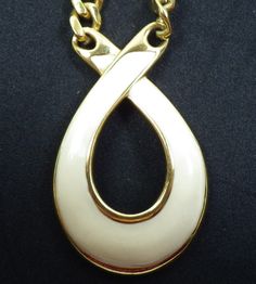 "This is a very attractive Napier necklace, a tear-drop/ribbon pendant with white enamel on a 24\" heavy link chain. The pendant measures approximately 2\"tall and 1.25\" wide and the clasp is a sturdy foldover, Napier patent 4,774,743. Please see the photographs for additional details of quality and condition before making your purchase." White Metal Necklace With Large Pendant, Vintage White Teardrop Jewelry, White Enamel Necklace With Large Pendant, White Teardrop Necklace With Large Pendant, Vintage White Teardrop Necklace, White Metal Jewelry With Large Pendant, White Enamel Jewelry With Large Pendant, White Enamel, Washer Necklace