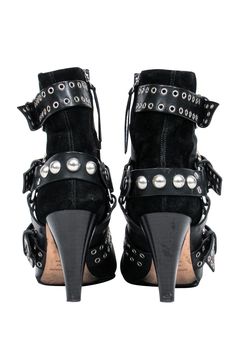 Unleash your inner rocker chick in these over-the-top booties from Isabel Marant. Buckles with grommets and studs adorn these edgy boots. Perfect for your next concert! Pair with distressed jeans and a leather jacket and you'll be sure to be invited on stage! Size 5.5 (FR 37) Leather upper w/ suede trim Buckled design w/ grommets and studs Interior side zipper closure Pointed toe Chunky heel Leather sole and footbed w/ very minor wear Heel 3.5" Studded Moto Boots For Concerts, Leather Boots With Rivets For Concert, Leather Rivet Boots For Concert, Leather Studded Boots For Concert, Rocker Leather Boots With Studs, Leather Rocker Boots With Studs, Edgy Studded Boots For Concerts, Studded Boots For Concerts In Fall, Black Studded Moto Boots For Concert