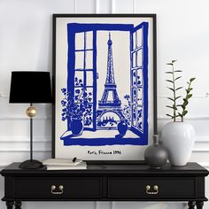 a blue and white print of the eiffel tower in paris is displayed on a table