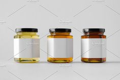 three jars filled with different types of honey