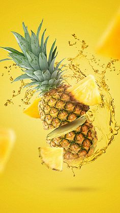 a pineapple is splashing into the air with slices of fruit in front of it