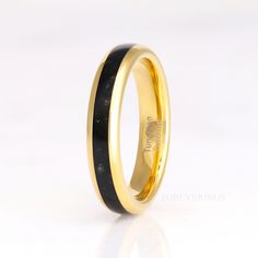 an image of a wedding ring with black and gold inlays on the inside