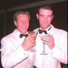 two men in tuxedos holding martini glasses