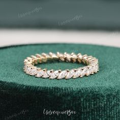 a gold ring sitting on top of a green box