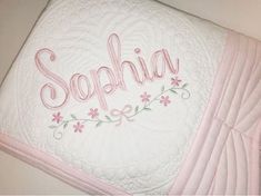 a pink and white blanket with the word sophiia written on it in cursive writing