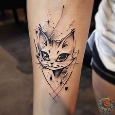 a black and white cat tattoo on the right leg, with geometric shapes around it