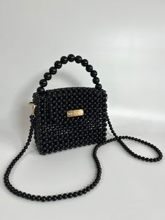 Bead bags are 100% handmade. Bead strap length can be changed upon request. It fits phone, card holder, lipstick, earphone case. It will come with a special pouch. The beads are navy in color. It is made with white or black pearls upon request. * Dimensions - Width: 20 cm - Height: 16 cm ( 26 cm with handle) - Depth: 8 cm - Strap Length: 108 cm * Materials - Luxury Plated Pearl - Gold Material * Shipping - Ships worldwide from İstanbul, Turkey. - Production time before shipment is 2-7 working da Handmade Black Handheld Evening Bag, Gift Black Beaded Shoulder Bag, Black Beaded Rectangular Shoulder Bag, Black Handheld Beaded Shoulder Bag, Rectangular Bag With Black Beads As Fashion Accessory, Black Bags With Pearl Handle As Gift, Black Bag With Pearl Handle As Gift, Black Bags With Pearl Handle For Gift, Black Beaded Handheld Shoulder Bag