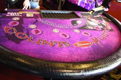 a purple casino table with lots of buttons on it