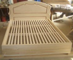 a wooden bed frame sitting on top of a table