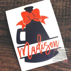 a sticker with the name madison on it sitting on top of a wooden table