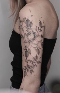 a woman with a flower tattoo on her arm