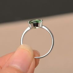 This is a gorgeous handmade creation. Its beauty is its simplicity & Elegance. The 6*8mm round cut lab green sapphire is crafted in solid sterling silver and with rhodium plated. All item is sent in a beautiful gift box You can realize more lovely stuff clicking the link https://www.etsy.com/shop/knightjewelry?refshopsection_shophome_leftnav Please leave the correct address and you phone number for delivering successfully. Green Solitaire Sapphire Ring In Sterling Silver, Green Sterling Silver Round Cut Birthstone Ring, Green Round Cut Sterling Silver Birthstone Ring, Green Sterling Silver Birthstone Ring Round Cut, Minimalist Oval Emerald Ring In Sterling Silver, Green Emerald Ring With Sterling Silver, Green Emerald Ring With Polished Finish, Green Oval Sterling Silver Birthstone Ring, Emerald Ring With Tension Setting