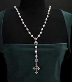 Paris Renaissance Rosary Necklace in Antique Silver You’re a lady of style, grace, and faith, and you reach for jewelry that embodies all of the things that make you special. You can showcase your distinguished sense of fashion and great devotion with the Paris Renaissance Rosary necklace. This striking rosary necklace is modeled after an authentic rosary pattern, divided into five decades. Lovely antique silver-capped pearls give way to five Our Father prayer beads and the Antiphon triad. A div Rosary Pattern, Lady Of Style, Our Father Prayer, Pearl Rosary, Gothic Crosses, Silver Caps, Rosary Necklace, Fan Earrings, Pretty Jewellery