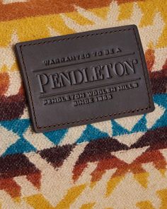 the label for pendleton's pendleton woolen mills is shown in brown and blue