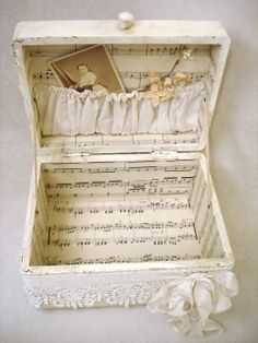 an open white box with music sheets inside