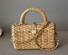 Vintage, Wicker, Women's Bag  with  gilded  strap in very   good condition! Retro hand made Wicker back! Lovely vintage find!  Take a good look at the photos, they are part of the description! ►Dimensions: 9/9 inches ►Period: Around 1970 ►Styles: Vintage ►Place of Origin: West Europe  ►Materials: Vinyl, Wicker, Metal ►Condition: Very Good  ►Condition Notes: Very Good item - N. 983/e Gold Rectangular Woven Shoulder Bag, Traditional Gold Shoulder Bag For Travel, Vintage Gold Shoulder Bag For Everyday Use, Gold Rectangular Bag With Brass Hardware, Gold Bags With Brass Hardware, Rectangular Shape, Gold Rectangular Bags With Brass Hardware, Gold Bohemian Rectangular Shoulder Bag, Vintage Gold Bag For Travel, Vintage Gold Travel Bag