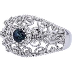 Gaze at the galaxy of glamour in this elegant 14K White Gold Sapphire Filigree Ring with Diamond Accents. Crafted to captivate, the centerpiece features a stunning sapphire, exuding a deep, enchanting blue hue. Delicate filigree work surrounds the center stone, adding an intricate touch of sophistication. Encircling the sapphire are sparkling diamonds, each meticulously set to enhance the brilliance of the ring. The combination of the vivid sapphire and the shimmering diamonds creates an aura of timeless elegance and refinement, perfect for elevating any ensemble with a touch of luxury.Indulge in the allure of fine craftsmanship and exquisite design with this breathtaking ring. Whether you're treating yourself or searching for the perfect gift for a loved one, this piece exudes grace and b Luxury Sapphire Ring With Intricate Design, Elegant Sapphire Ring With Intricate Diamond Design, Elegant Sapphire Ring With Intricate Design, Elegant Sapphire Ring With Intricate Design For Anniversary, Elegant Sapphire Halo Ring, Luxury Sapphire Ring With Intricate Design For Formal Occasions, Elegant Blue Sapphire Ring, Fine Jewelry Sapphire Ring With Filigree, Intricate Design Sapphire Ring Fine Jewelry