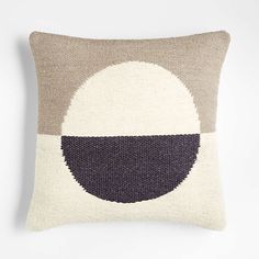 a pillow with an oval design on it in grey, white and brown colors is shown