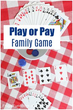 play or pay family game with cards and dices on a checkered tablecloth