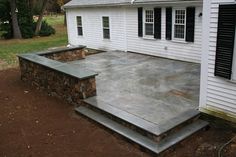 an outdoor patio with steps leading up to the house