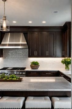 a kitchen with marble counter tops and dark wood cabinets, along with white stools