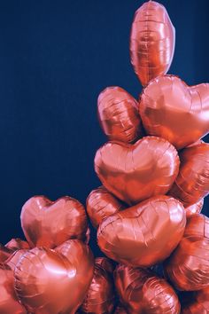 a pile of heart shaped balloons sitting on top of each other