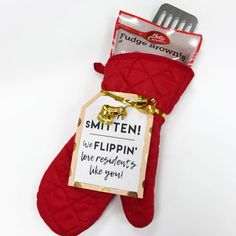 a red mitt with a sign on it that says smitten we flippin