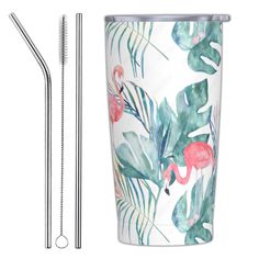 two stainless steel straws, one with flamingos and the other with palm leaves