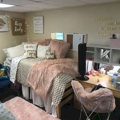 a dorm room with a bed, desk and chair