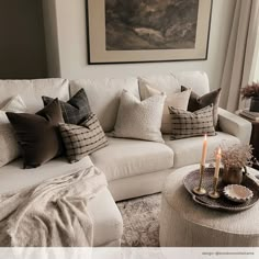 a living room filled with white furniture and pillows