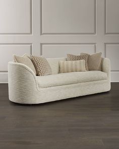 a white couch sitting on top of a hard wood floor