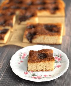 a piece of cake sitting on top of a white plate next to a wooden table