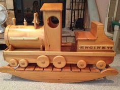 a wooden toy boat sitting on top of a table