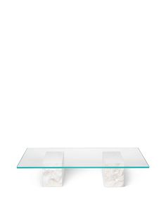 a glass table with two white blocks on it