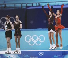 three olympic figure skaters performing on the ice