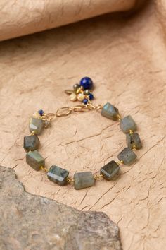 Discover the vibrant and stunning colors of the Blue Moon Collection in this eclectic bracelet! Gold Filled (Lead & Nickel Free) Pyrite, Lapis Lazuli, Labradorite, Mother Of Pearl 7.5-8.5" adjustable length, with gold filled lobster claw clasp We hand select our natural materials, thus there may be slight variations in color and/or size that will not detract from the overall aesthetic. Our unique handcrafted designer jewelry for women is made in America, each design created individually in our p Silver Gold Earrings, Silver Gold Necklace, Pyrite Necklace, Moon Collection, Pearl Design, Simple Bracelets, Gold Collection, Blue Moon, Lapis Lazuli