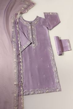 Curated on soft pure raw silk 60 gms in an enchanting Lilac hue, with intricate creamy threadwork alongside clusters of hand sewn pearls and pretty laces. The dupatta is adorned with signature embroidered laces, styled with flappers for a head turning look. The length of the long kameez is 47 inches. Order Duration: 4 Elegant Churidar In Dola Silk For Reception, Elegant Dola Silk Churidar For Reception, Silk Sharara With Pearl Embroidery For Reception, Silk Churidar With Intricate Embroidery For Reception, Festive Silk Sharara With Pearl Embroidery, Wedding Anarkali Set In Raw Silk With Pearl Embroidery, Bollywood Style Silk Sharara With Pearl Embroidery, Festive Georgette Dupatta With Pearl Embroidery, Wedding Traditional Wear In Raw Silk With Pearl Embroidery