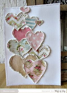 a close up of a card with many hearts on the front and back of it