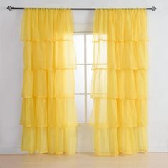 a yellow curtain hanging on the side of a window